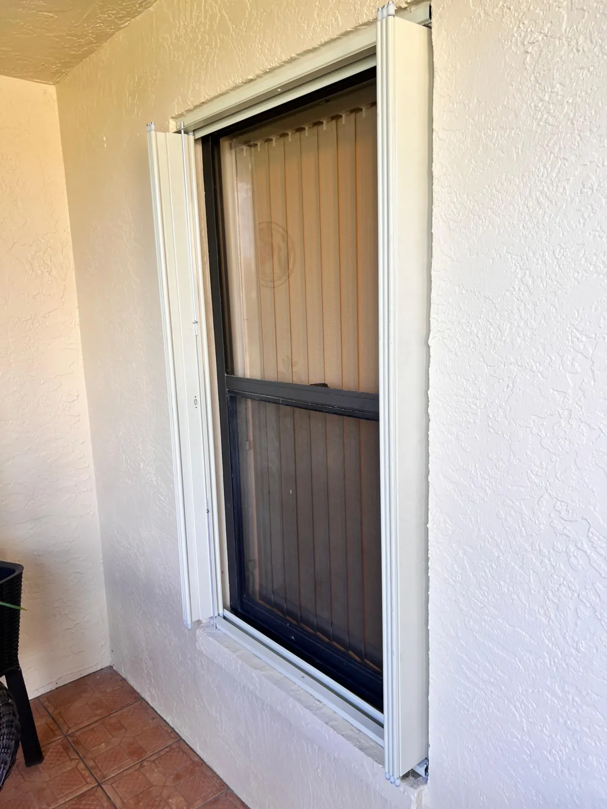 Aluminum shutter closure installed at a protected building opening