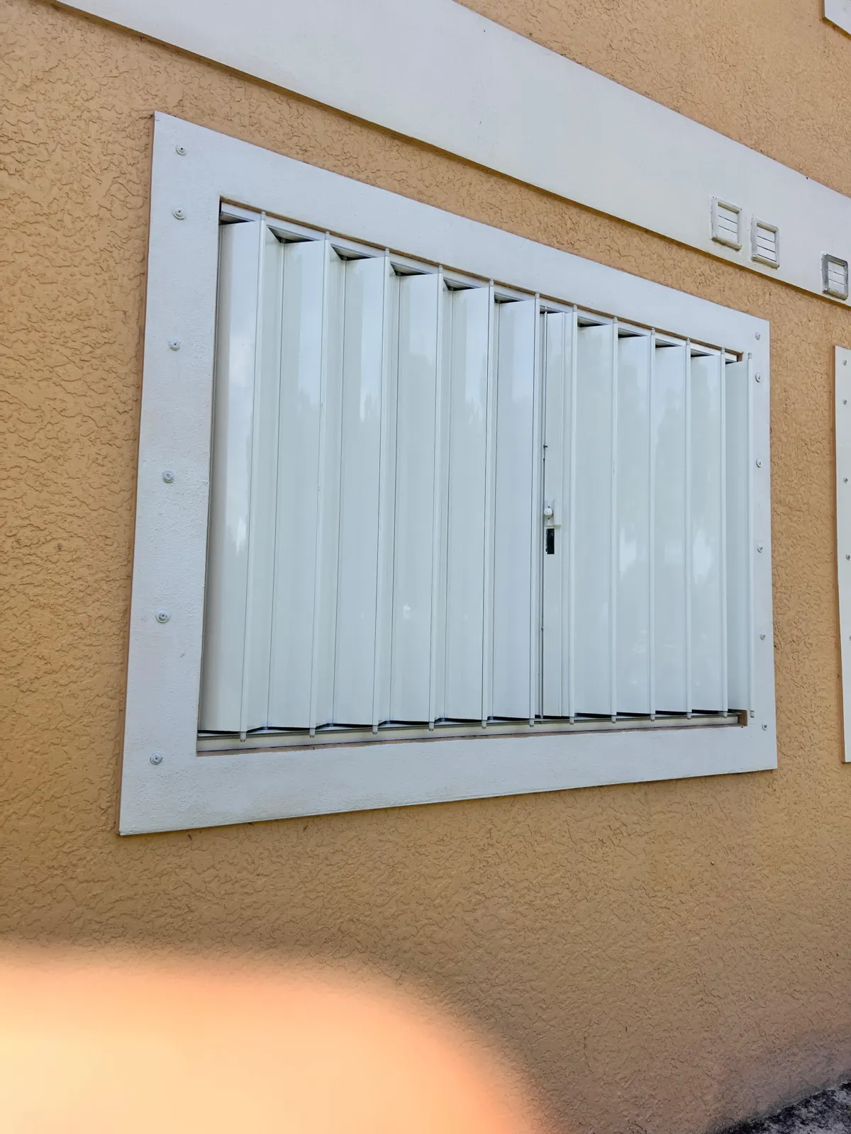 Metal security shutter installed across an exterior opening