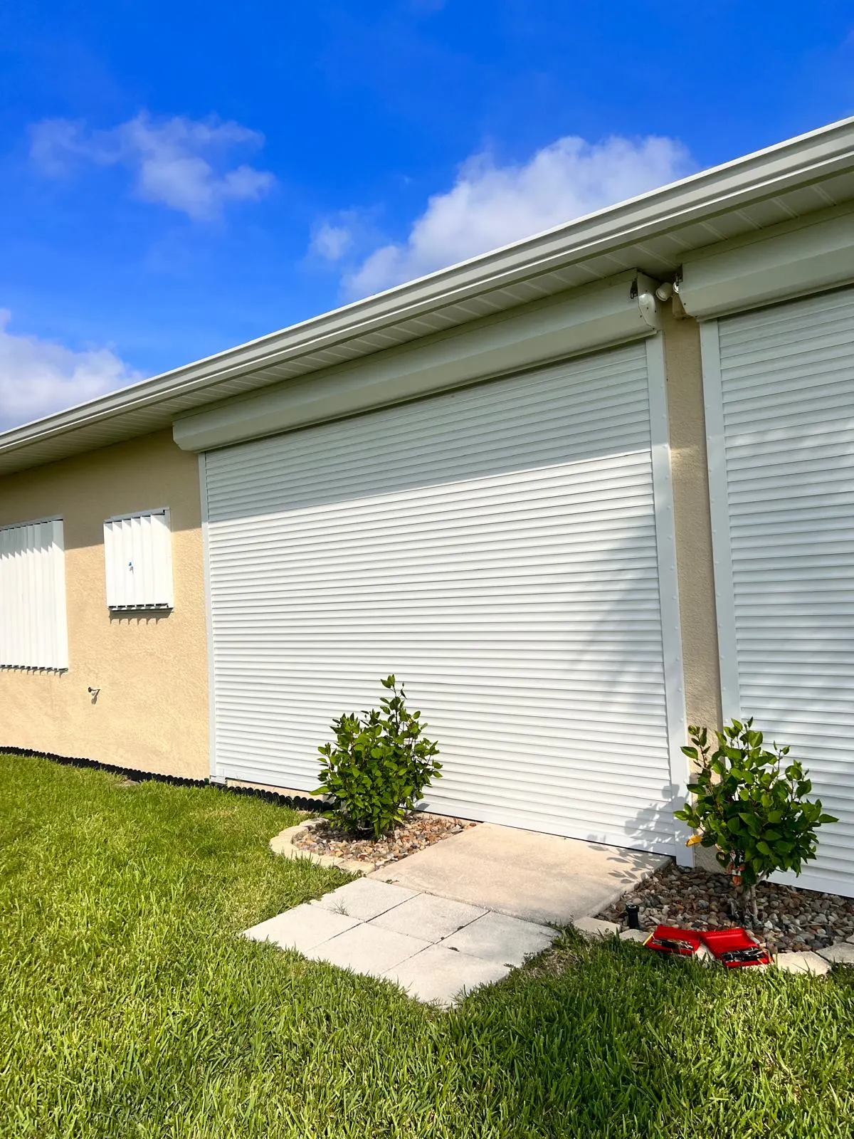 Exterior roll-down shutters installed over a residential opening